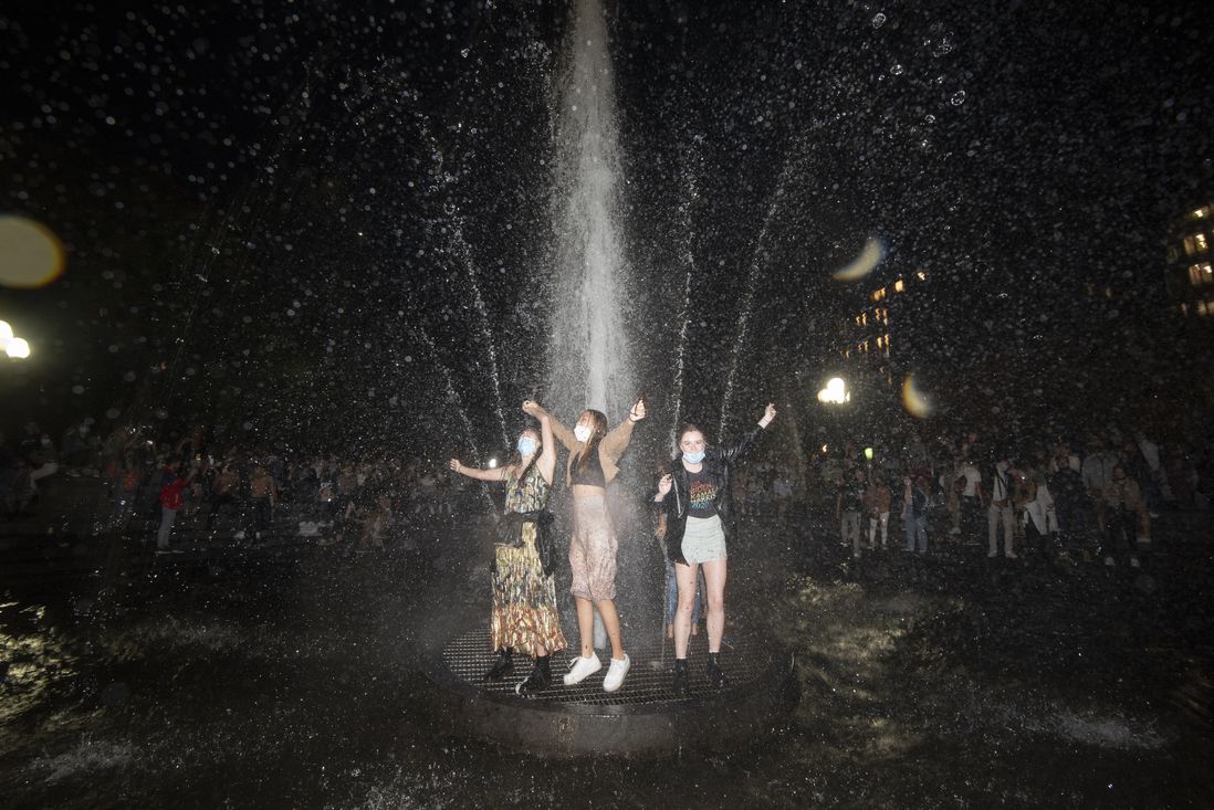 People in the fountain in Washington Square Park